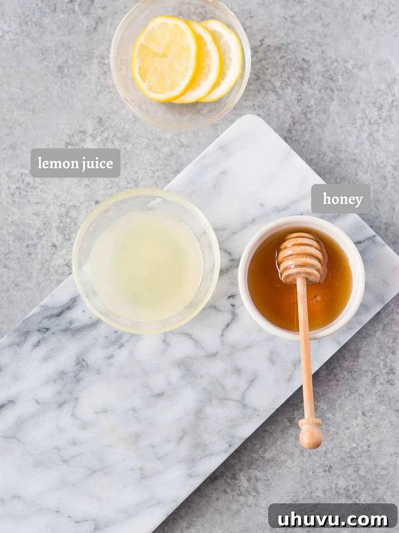 Ingredients for lemon tea: fresh lemon juice, honey, and lemon slices.