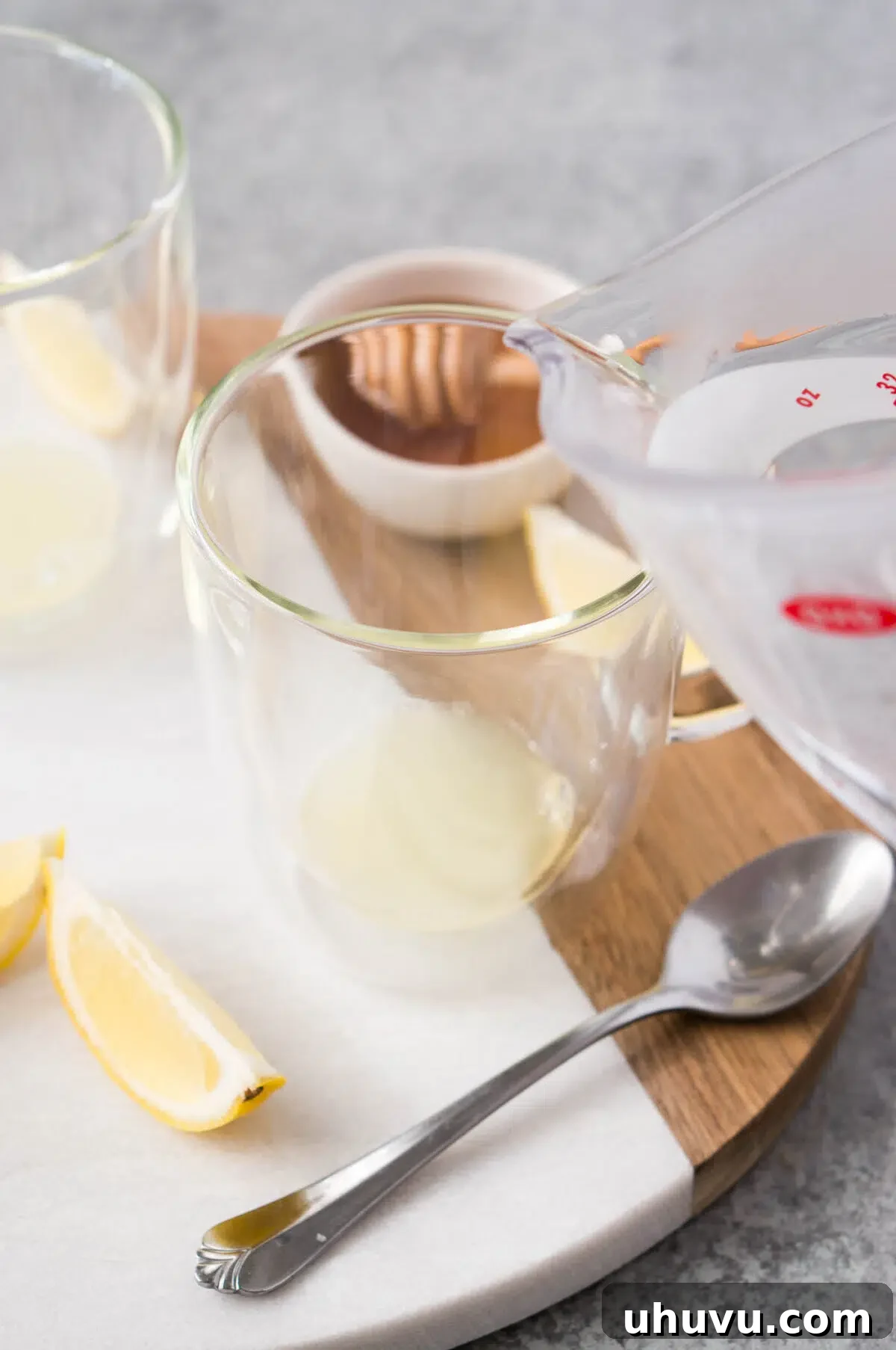 Freshly squeezed lemon juice collected in a clear glass cup.