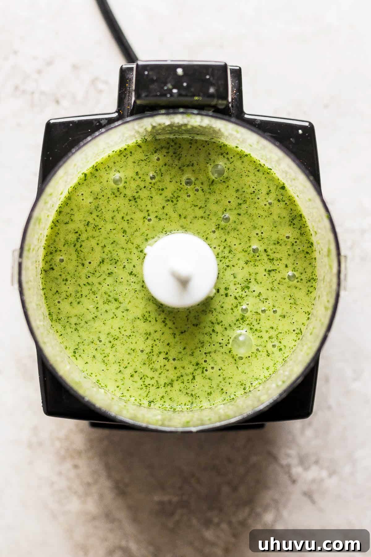 Zesty Cilantro Lime Chicken 6 The perfectly blended, smooth, and vibrant green cilantro lime chicken marinade in a food processor, ready for use.