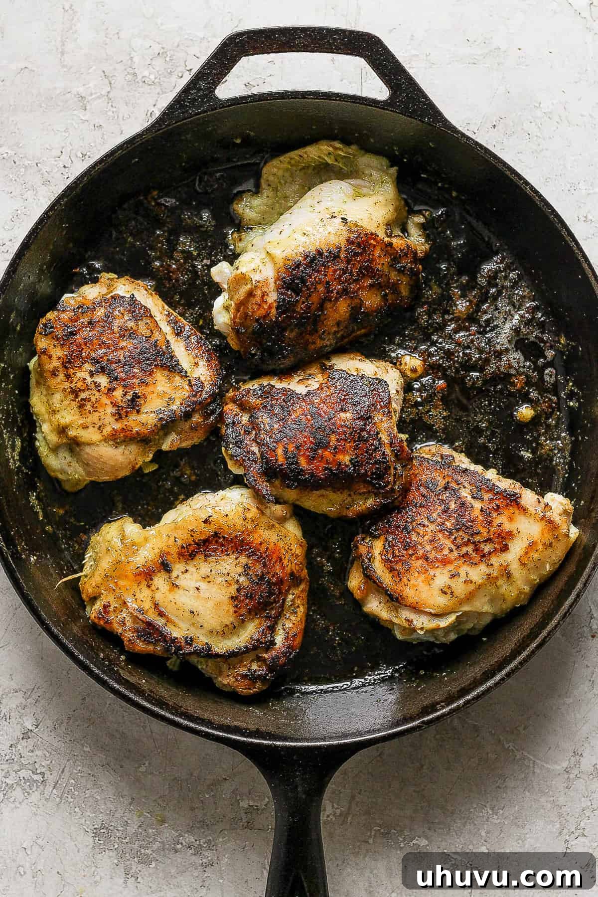 Zesty Cilantro Lime Chicken 9 Perfectly seared cilantro lime chicken in a skillet, showcasing crispy golden-brown skin, ready for the oven.
