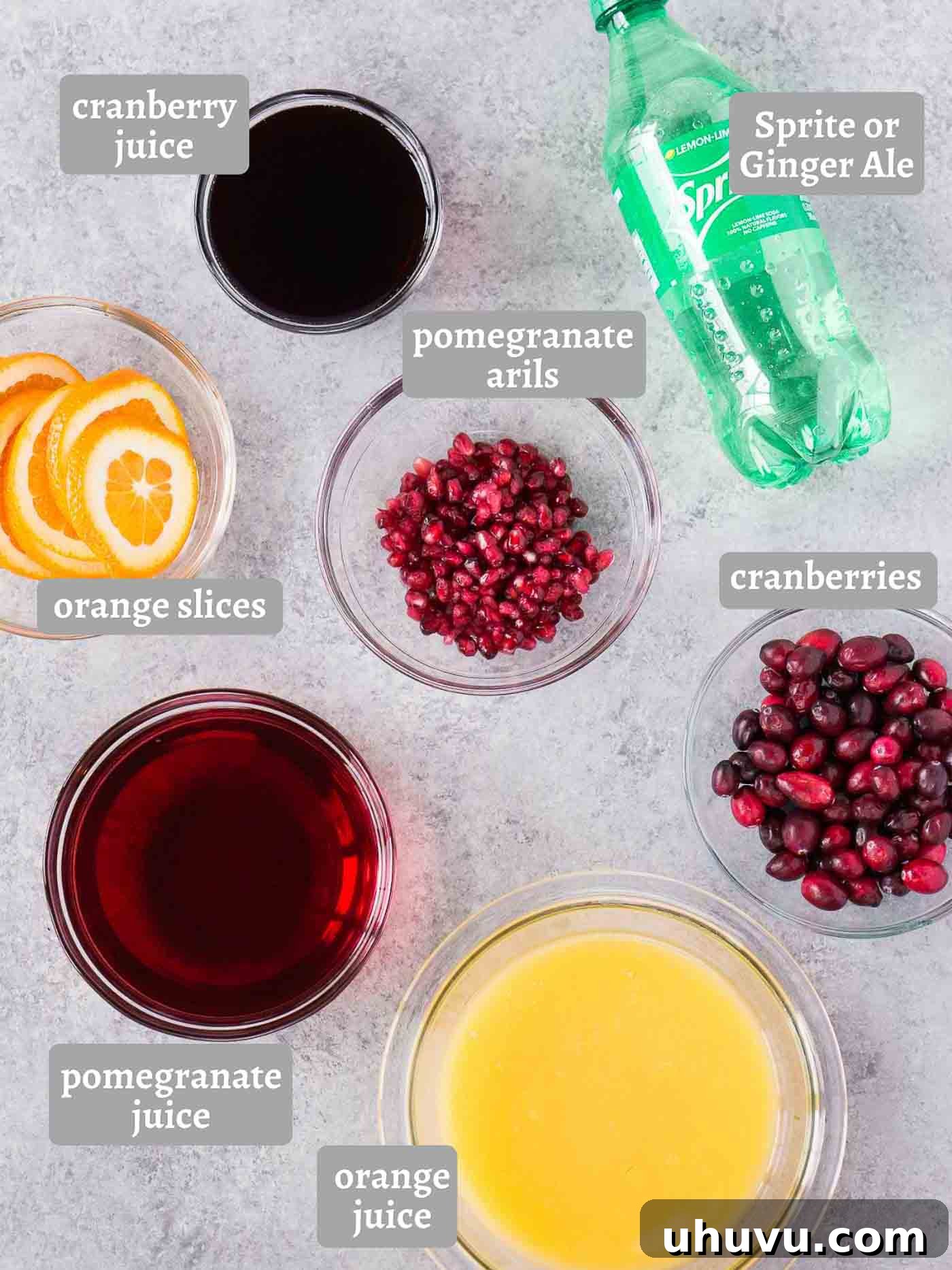 Merry Mixer 3 Ingredients laid out for making holiday punch, including cranberries, oranges, pomegranate, and juices