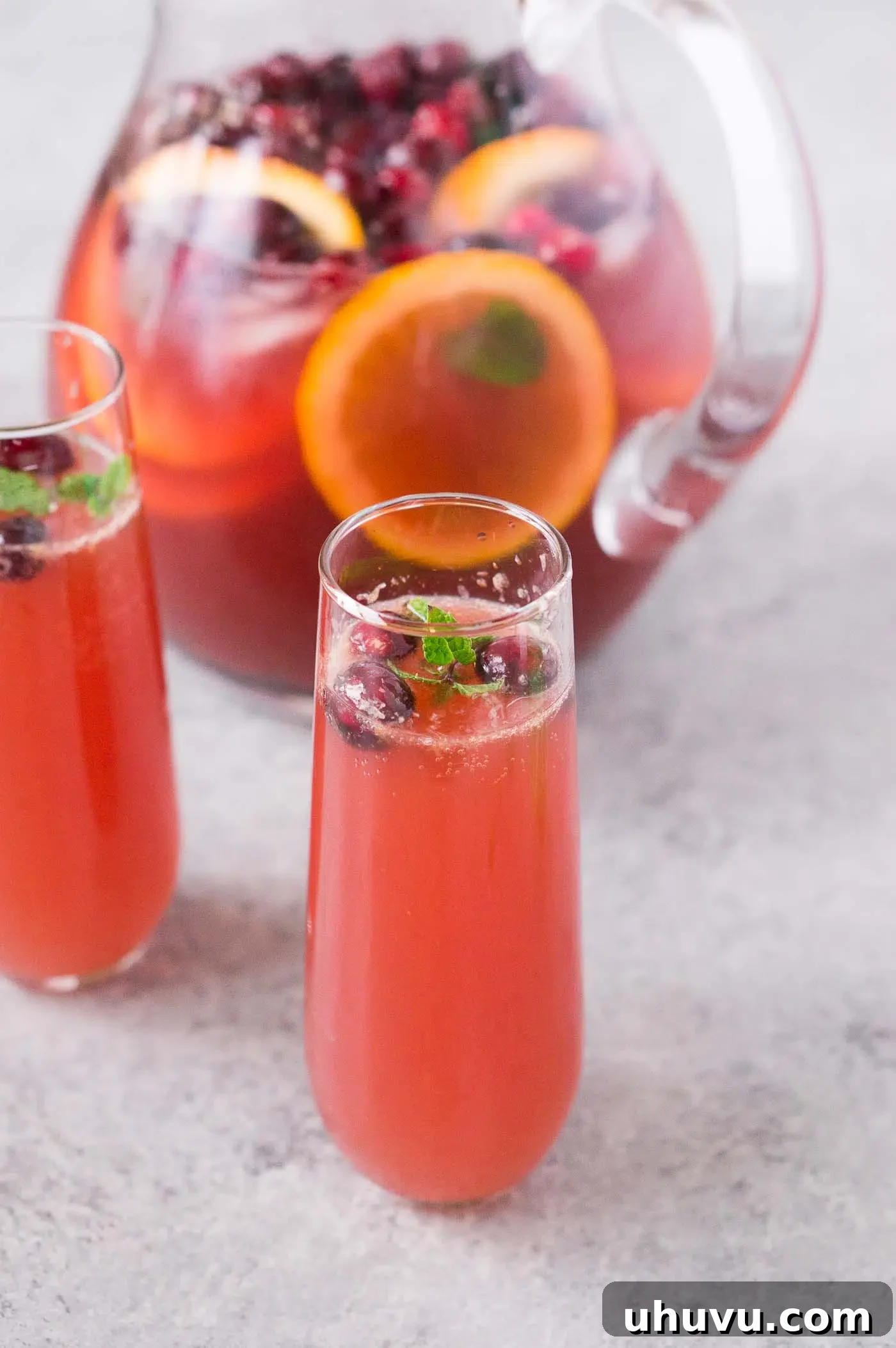 Merry Mixer 6 Non-alcoholic holiday punch elegantly served in glasses with a pitcher in the background