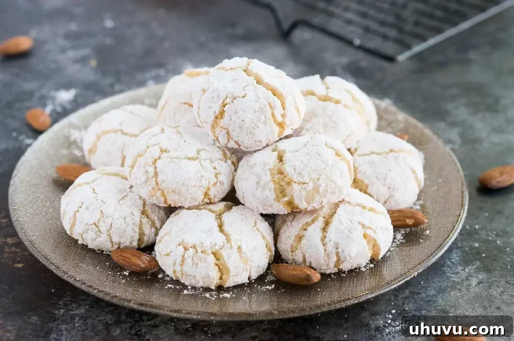Classic Italian Amaretti 3 A stack of golden-brown gluten-free almond cookies, showing off their delicate texture on a white plate.