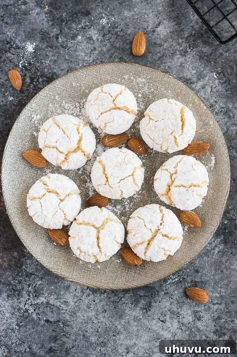 Classic Italian Amaretti 9 Freshly baked gluten-free amaretti cookies elegantly arranged on a silver serving plate.