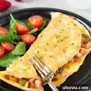 western omelet with greens and cherry tomatoes on a plate