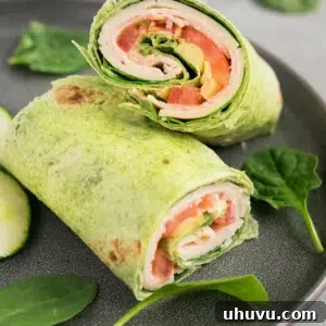 Low carb turkey club wrap sliced on a plate for the recipe card