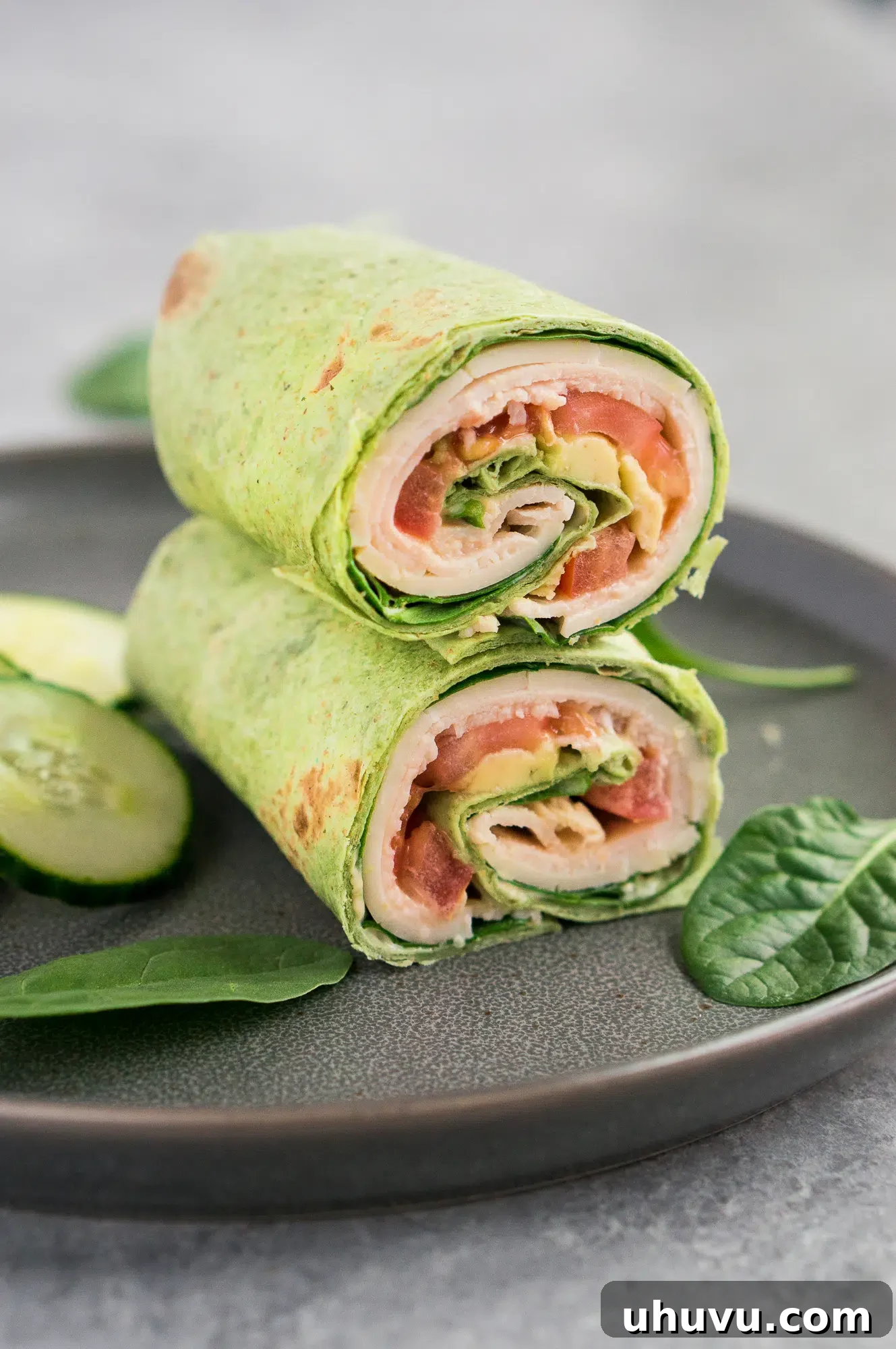 Stacked low carb turkey club wraps on a white plate