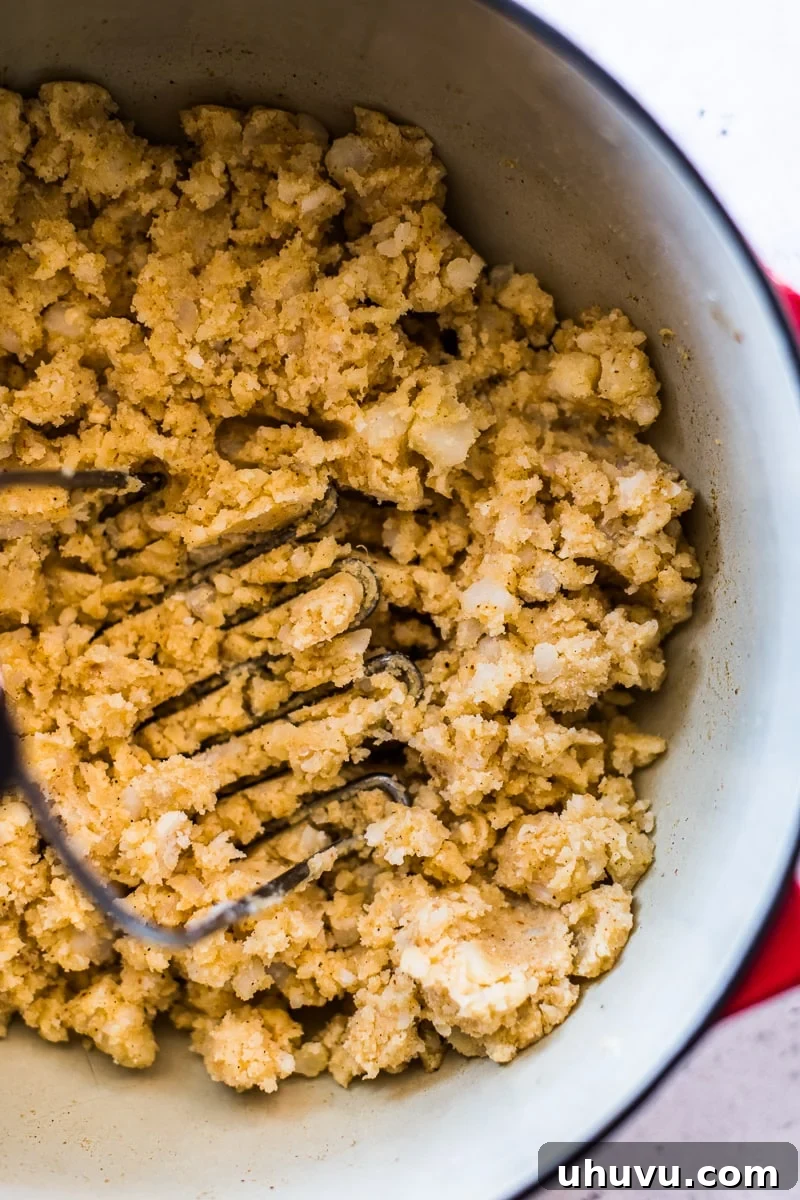 Crispy Golden Potato Tacos 3 Mexican-spiced mashed potatoes in a Dutch oven, ready to be used as filling for Crispy Potato Tacos.