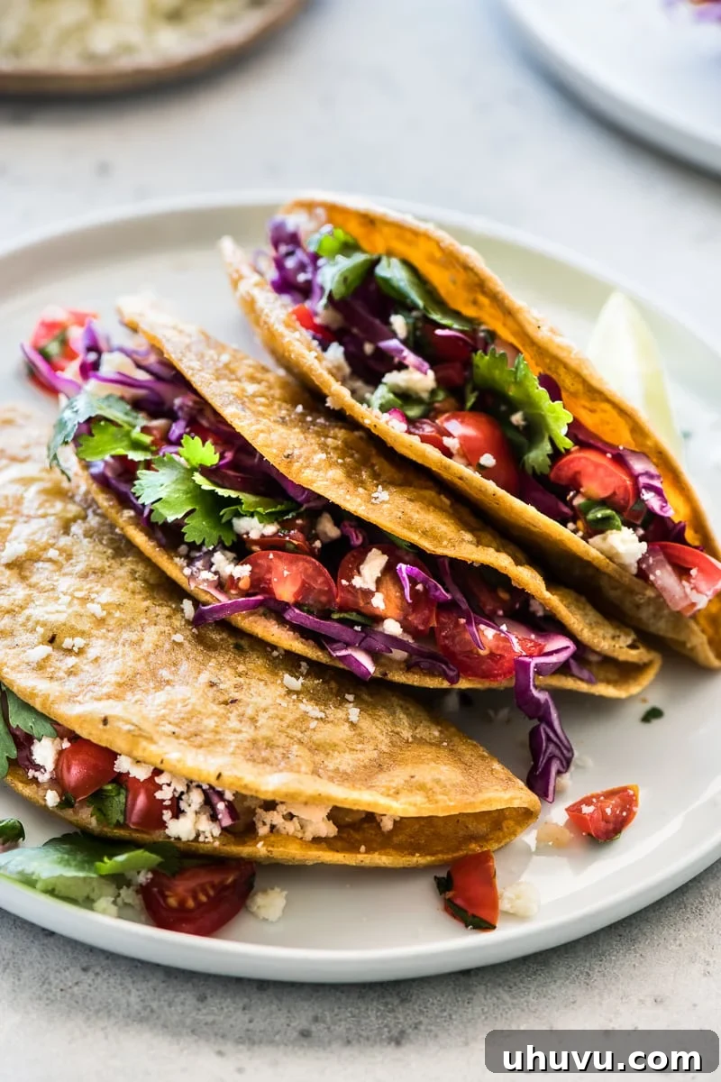 Crispy Golden Potato Tacos 6 Crispy Potato Tacos filled with shredded cabbage, pico de gallo, and cotija cheese, ready to be enjoyed.
