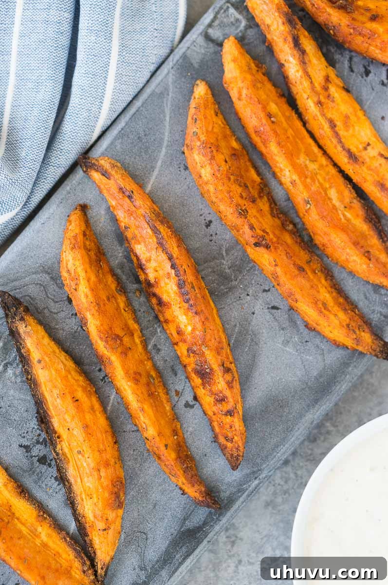 close up shot of roasted crispy sweet potatoes, showing off their texture and seasoning