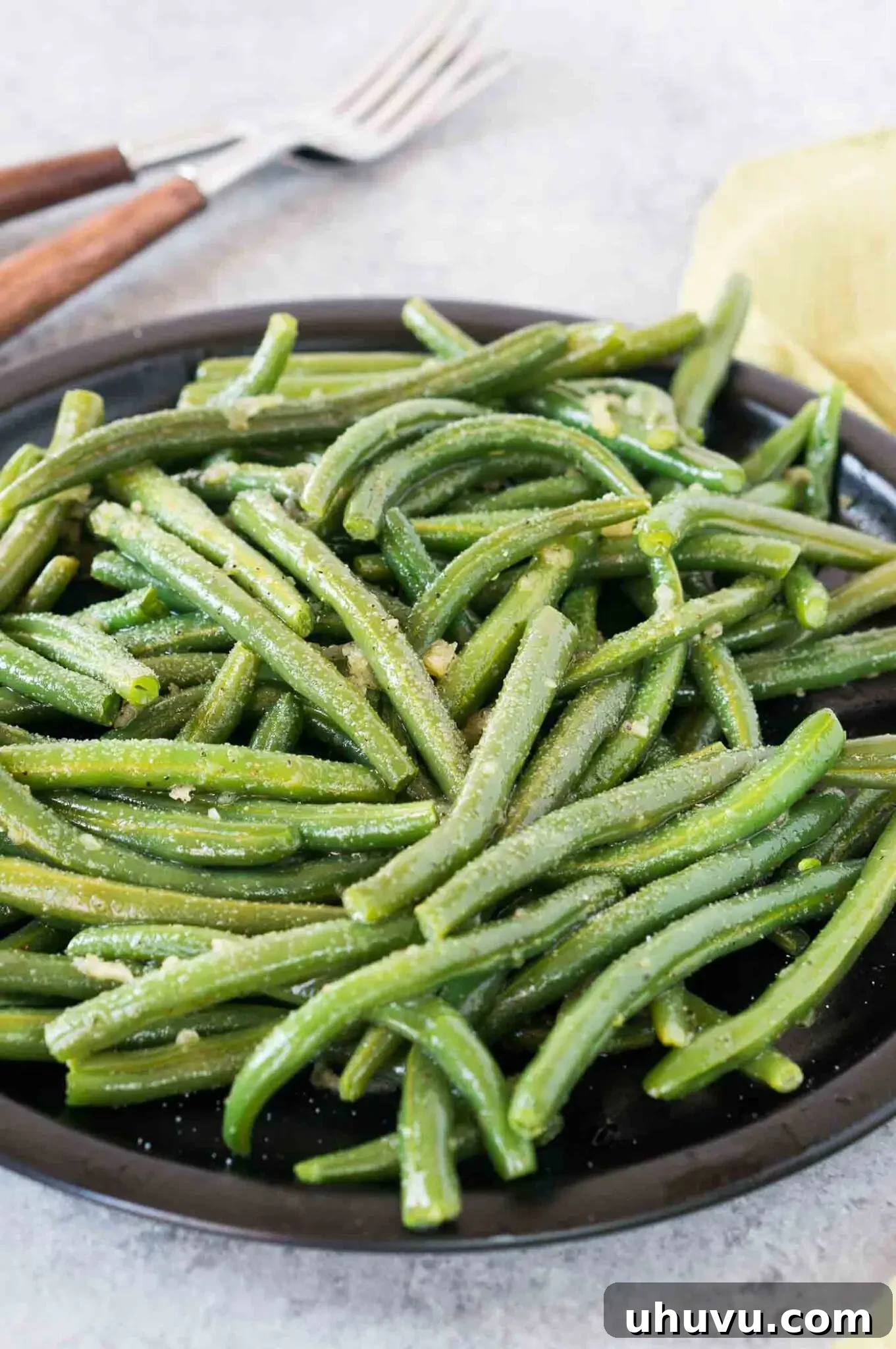 seasoned pressure cooked green beans on a black plate