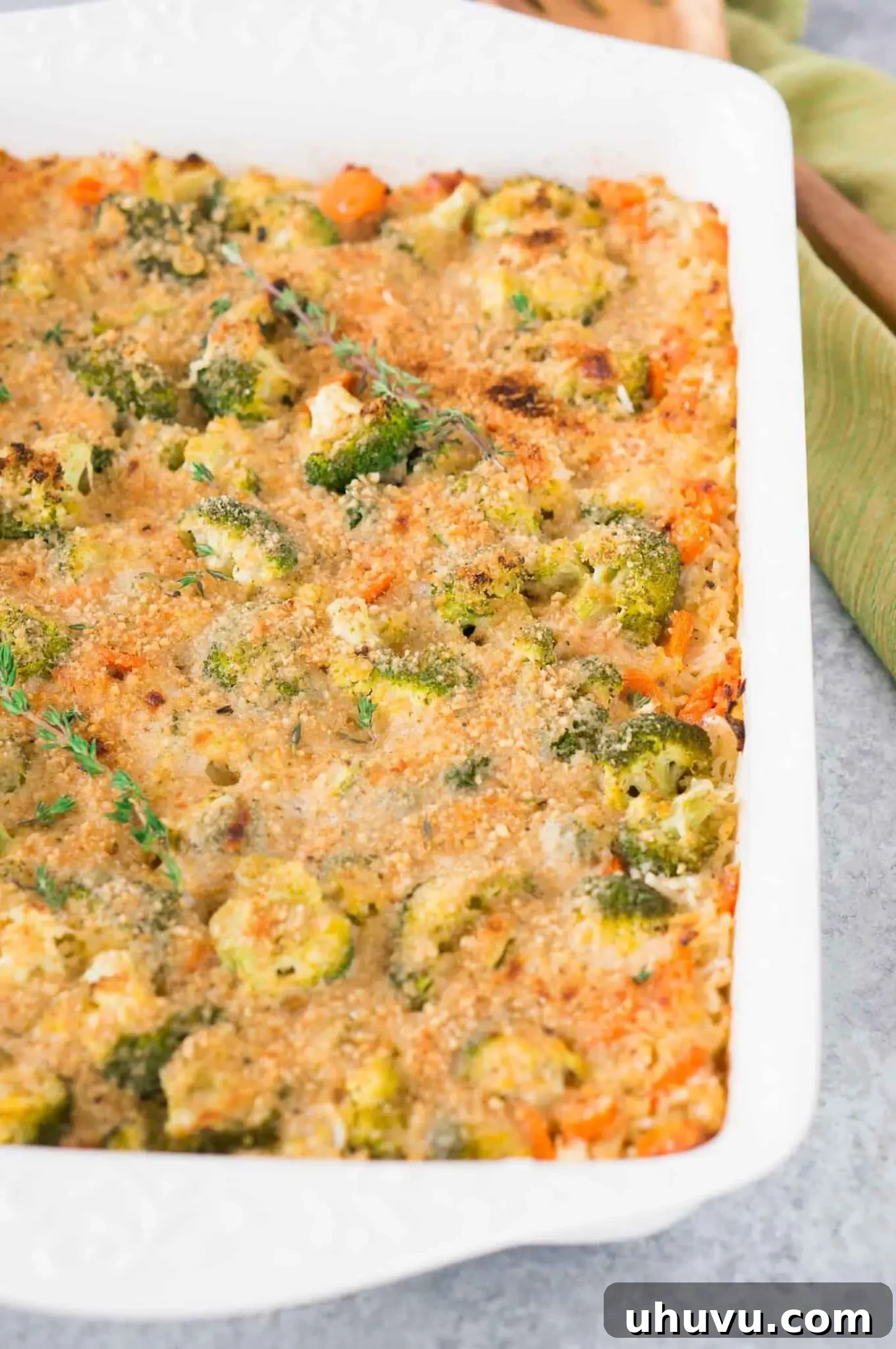 Close-up of the bubbling, cheesy broccoli rice casserole fresh out of the oven, with a crispy golden topping