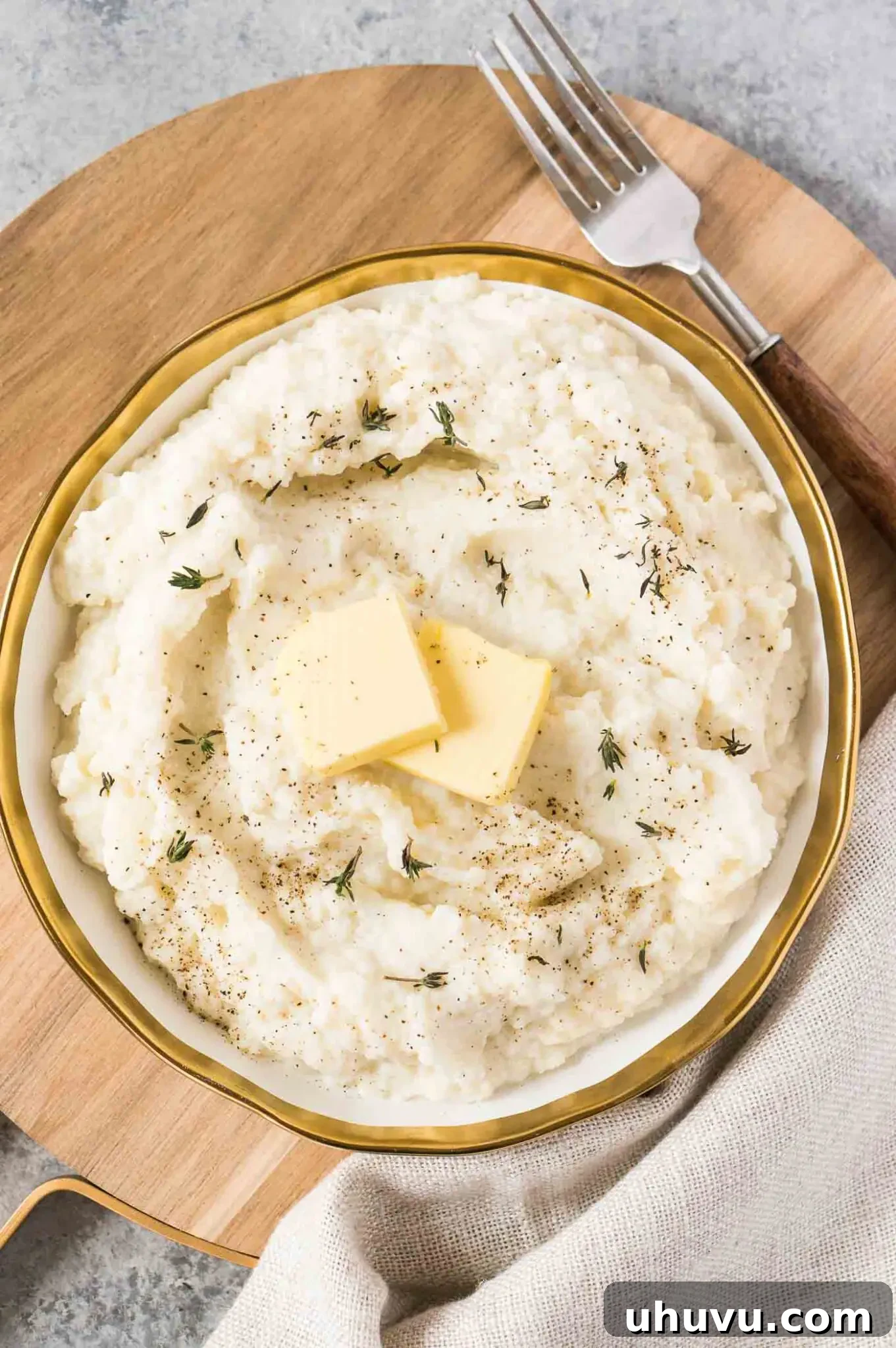 A serving of keto mashed cauliflower in a sleek white bowl, ready to be enjoyed.