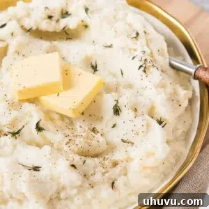Creamy garlic mashed cauliflower in a white bowl
