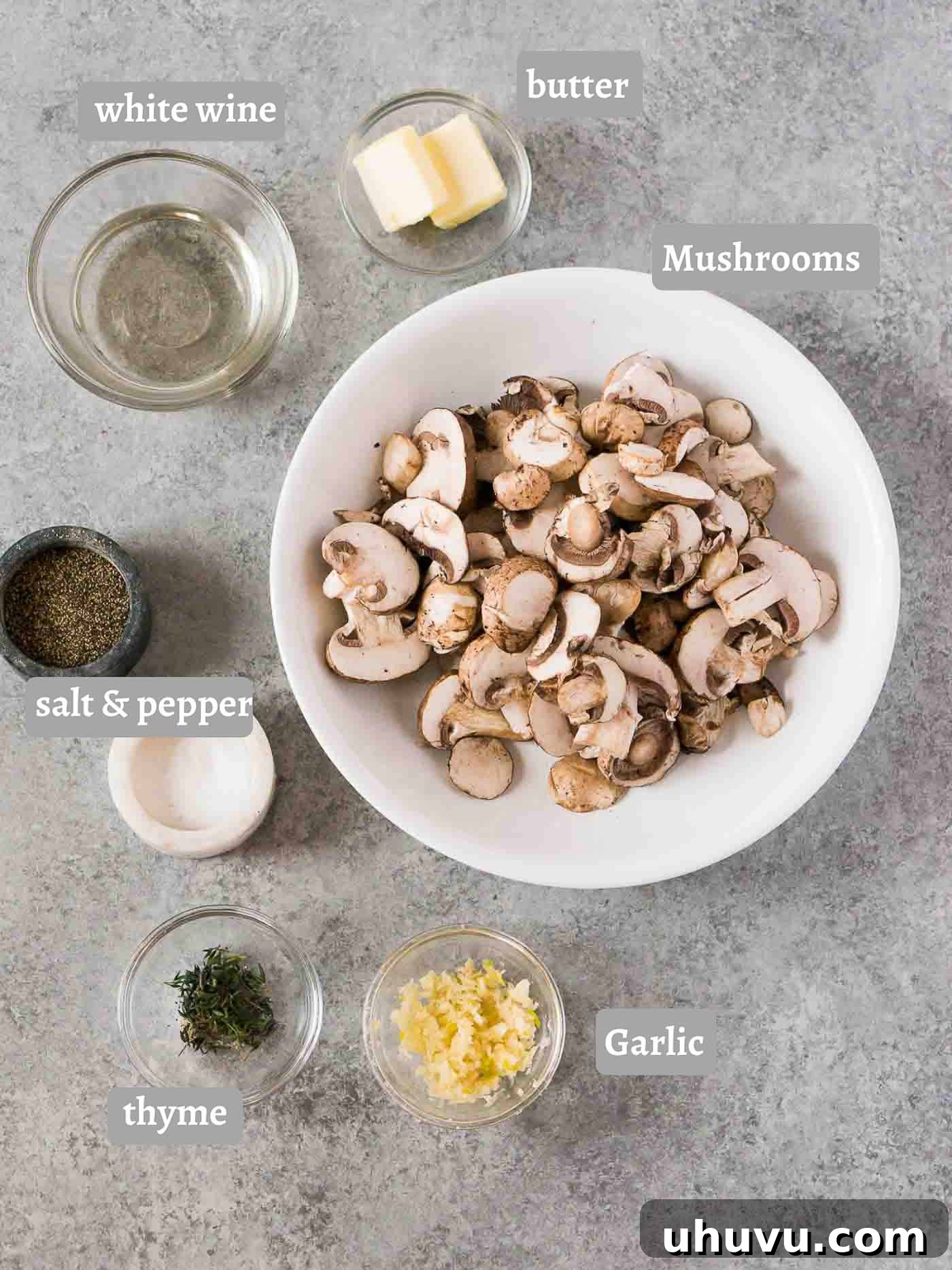 Garlic Butter Mushrooms 4 Ingredients laid out for making sautéed mushrooms including fresh mushrooms, garlic, herbs, and sauces