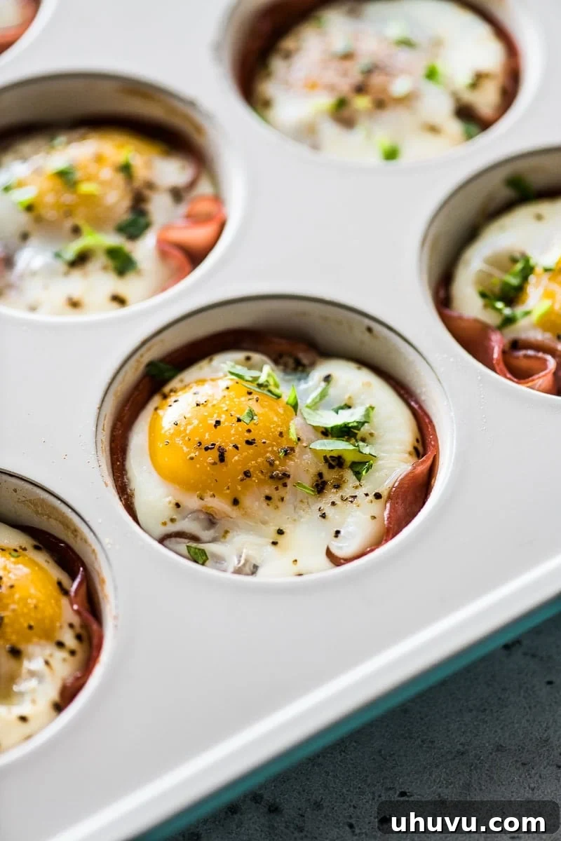 Poblano and Ham Egg Bake 2 Baked eggs in a muffin tin with ham, roasted poblanos, and topped with chopped cilantro.