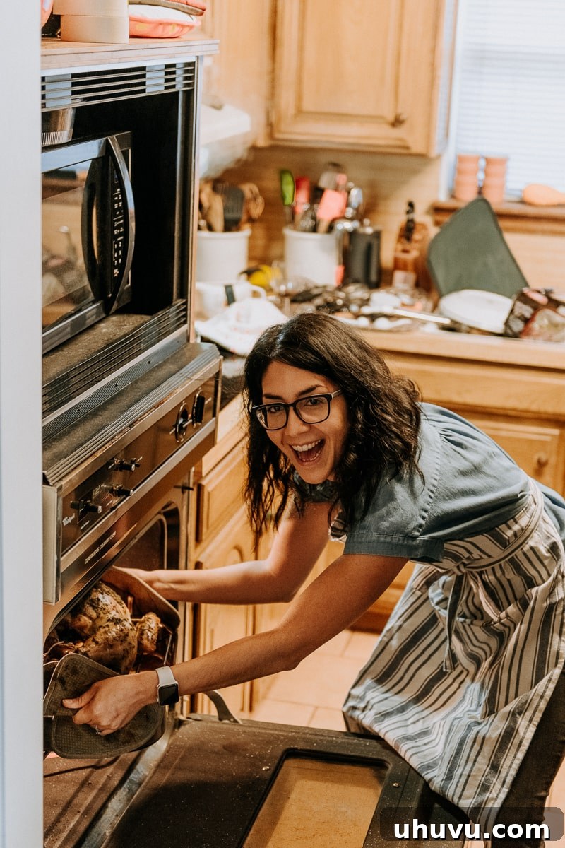 Friendsgiving Fun: Tips, Tricks, and Treats 9 Isabel of Isabel Eats carefully removing the perfectly roasted Friendsgiving turkey from the oven.