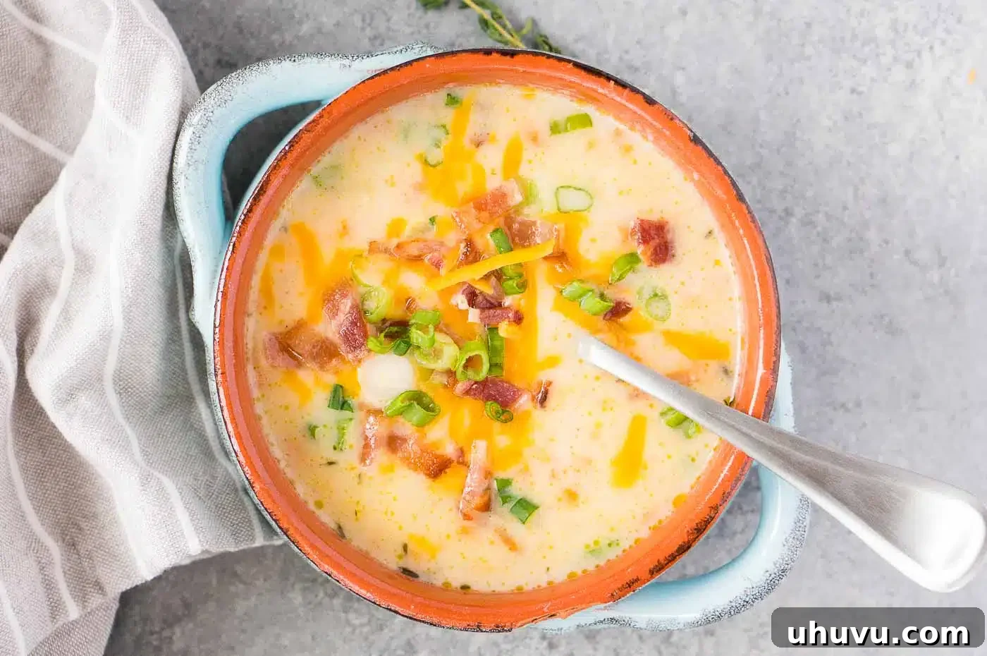 close up shot of loaded potato soup in a bowl with generous toppings