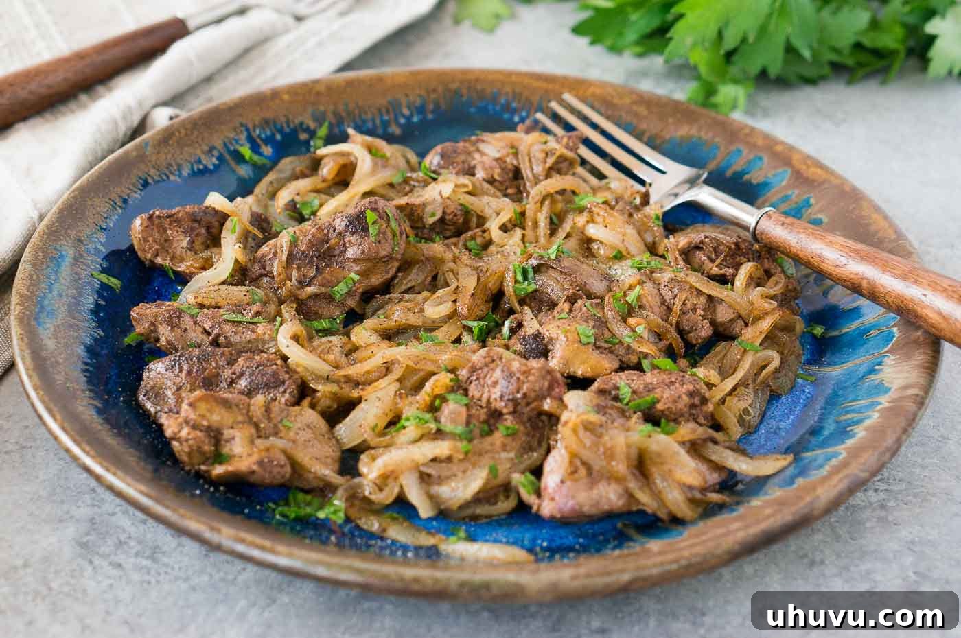 livers and onions on a blue plate