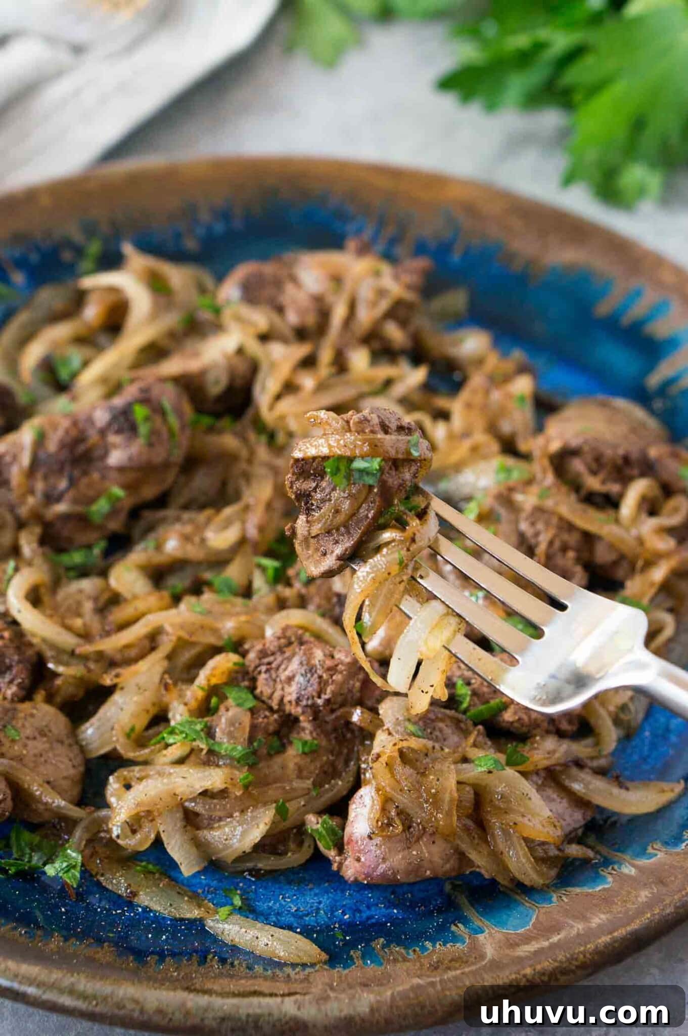 close up image of livers and caramelized onions on a plate