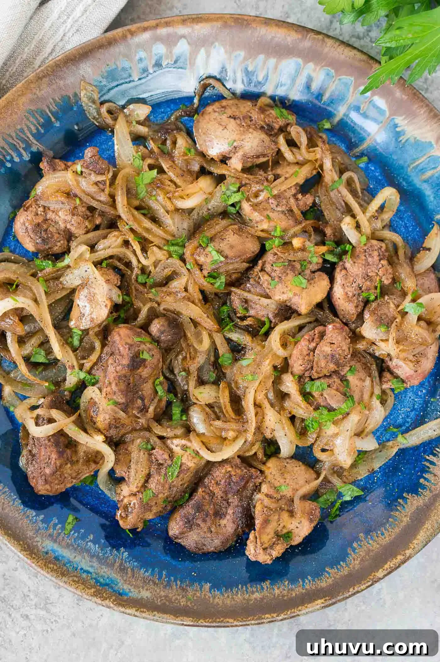 close up image from top of livers and onions on a plate