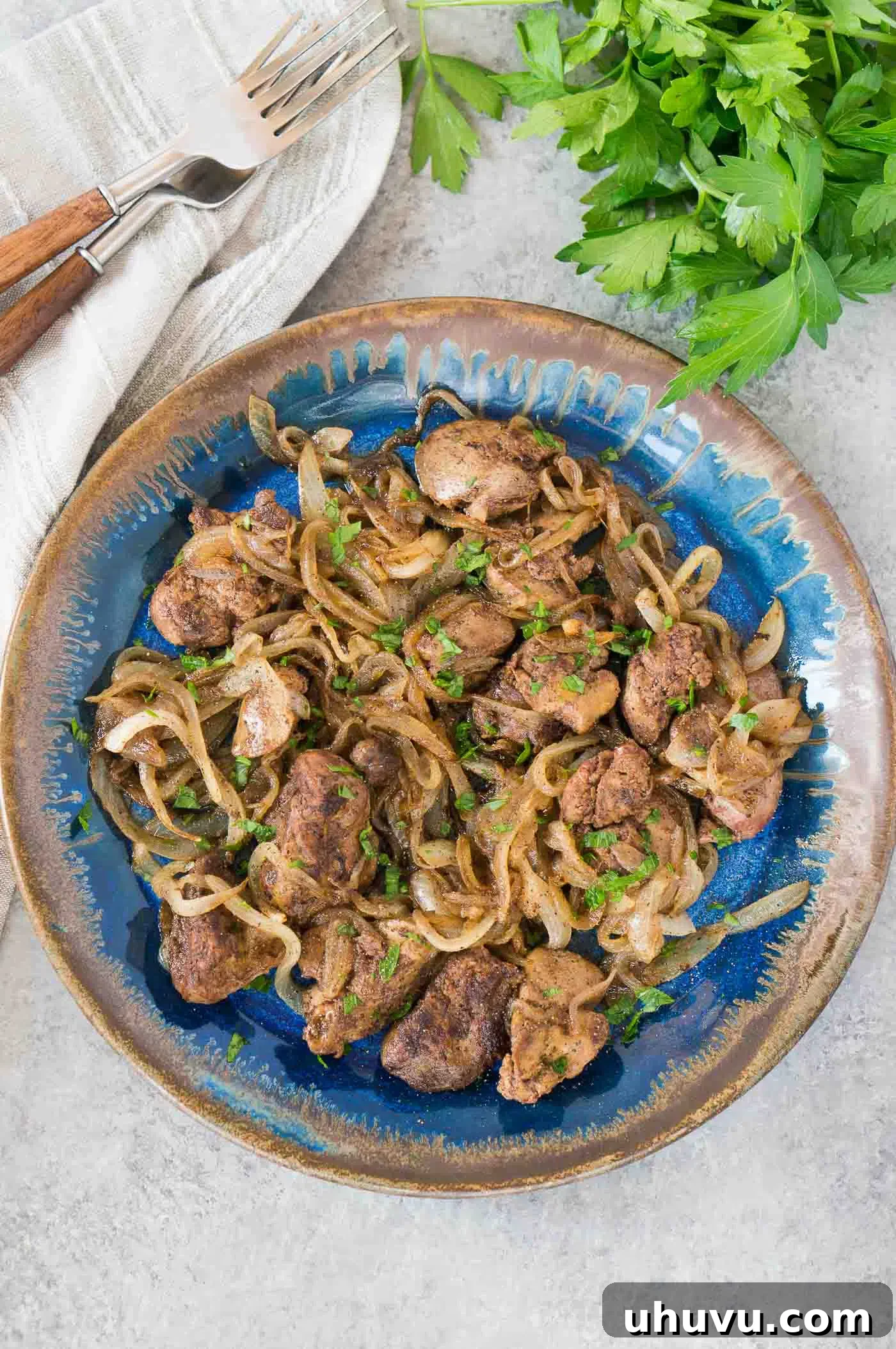 delicious chicken livers and onions served on a plate