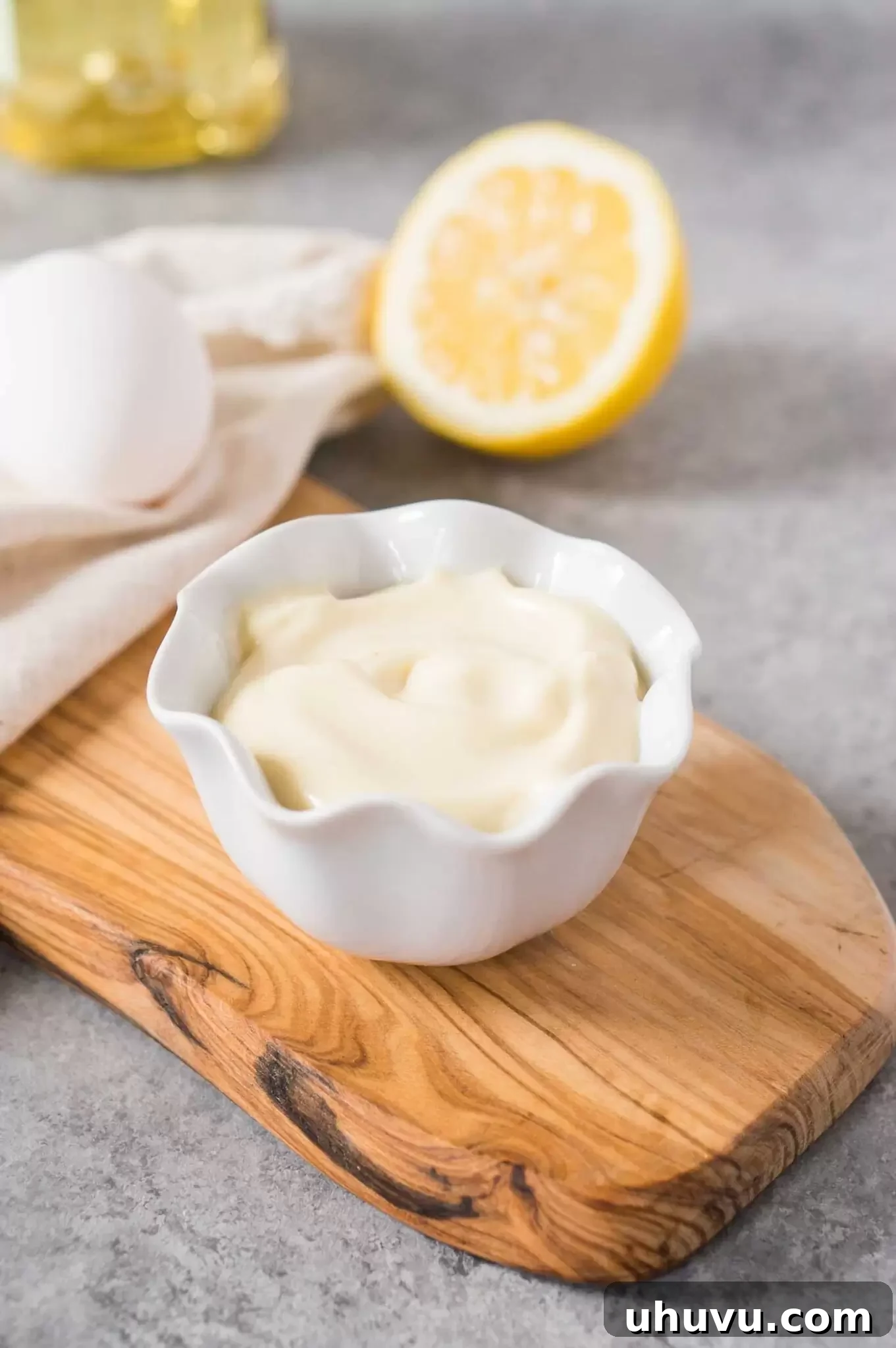 Delicious, creamy basic mayonnaise recipe elegantly served in a small white bowl with a spoon