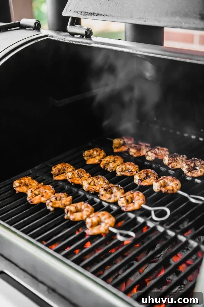 Spicy Grilled Shrimp Tacos with Avocado Crema Slaw 4 Shrimp threaded onto metal skewers, cooking directly over glowing charcoal on a grill, radiating a smoky aroma.