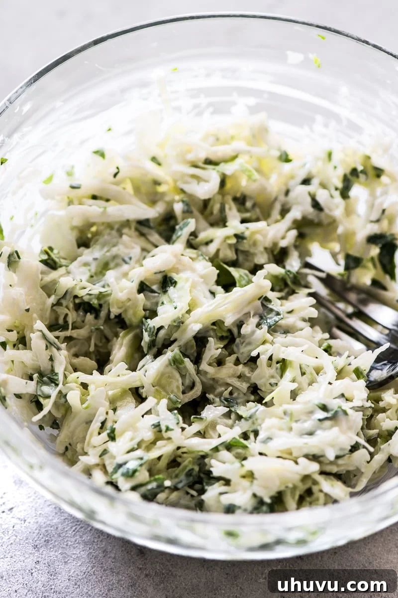 Spicy Grilled Shrimp Tacos with Avocado Crema Slaw 7 A generous bowl of creamy, fresh cabbage slaw, mixed with cilantro and ready to be served as a vibrant topping for tacos.