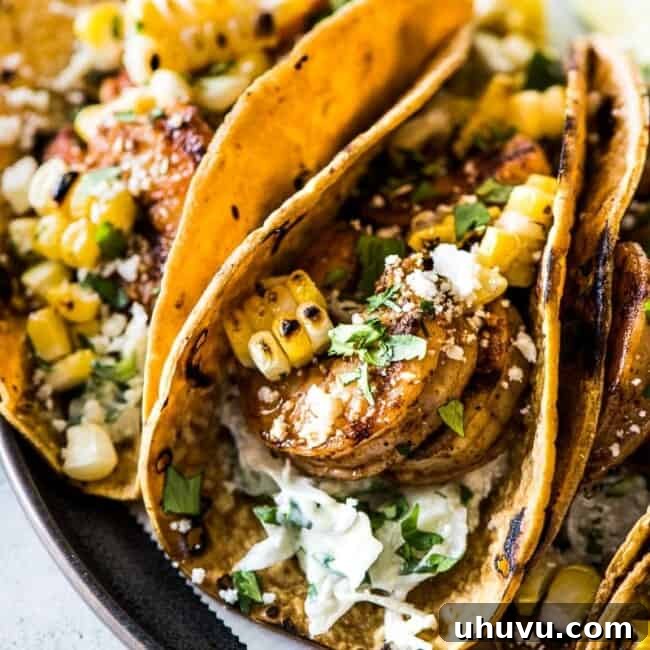 Delicious Grilled Shrimp Tacos with Creamy Slaw, served on warm corn tortillas.
