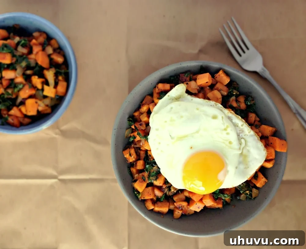 Kale and Sweet Potato Breakfast Hash topped with a perfectly cooked sunny-side up egg