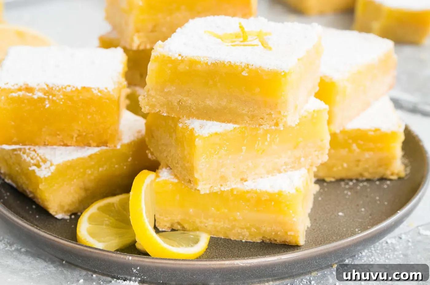 Lemon squares arranged beautifully on a white plate