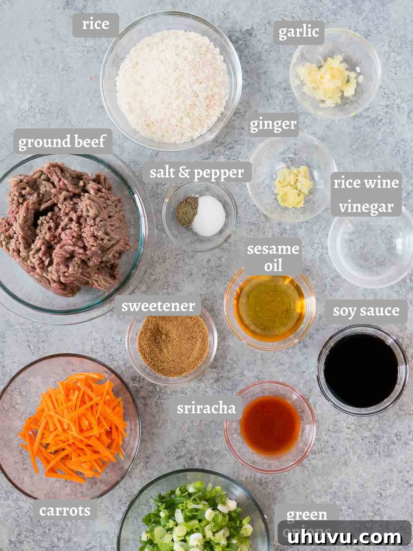 Assortment of fresh ingredients laid out for Korean beef bowls: ground beef, rice, vegetables, and sauces