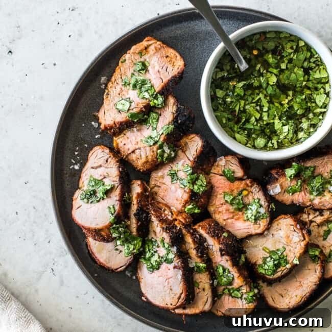 Grilled Pork Tenderloin is an all-time grilling favorite! Rubbed with a blend of smoky spices like chipotle powder, ground cumin and smoked paprika, this recipe makes unbelievably juicy pork every single time. #porkrecipes #grillingrecipes #porktenderloin