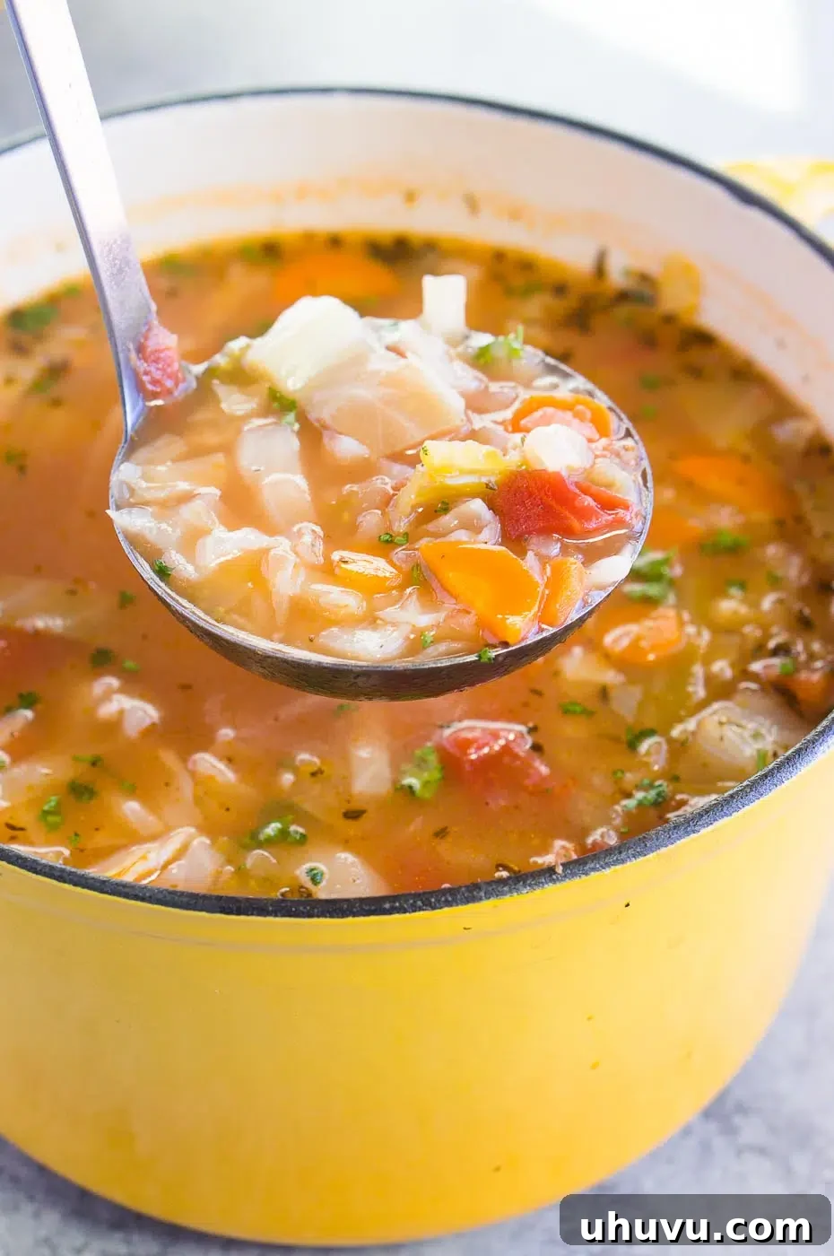 serving vegetable soup with cabbage, a wholesome and filling meal