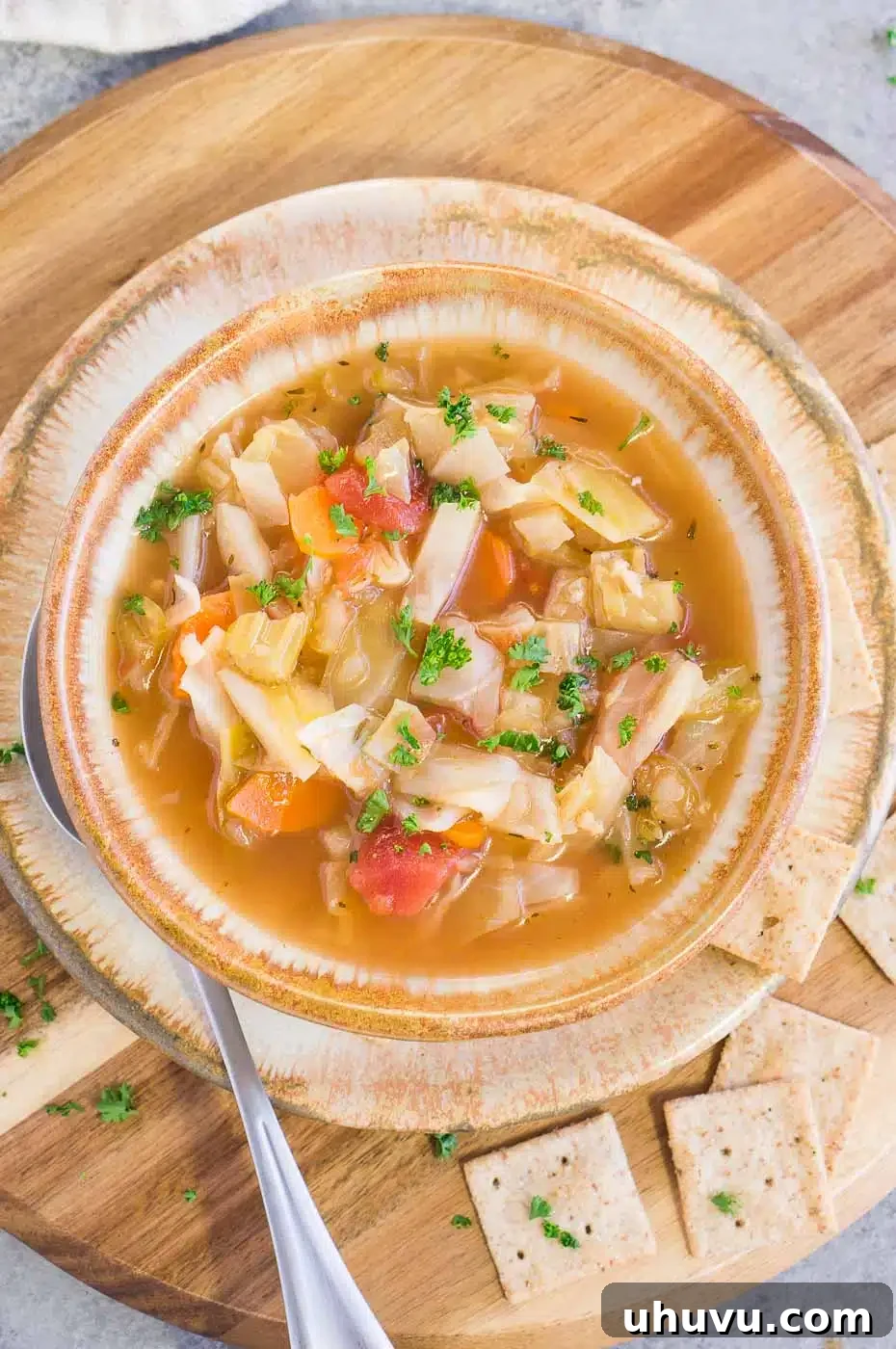 old fashioned cabbage soup served in a bowl with crackers, an easy and healthy dinner