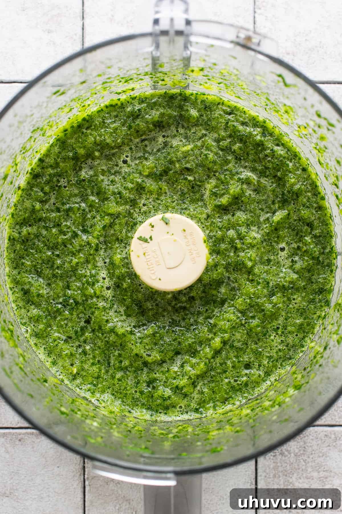 Zesty Green Rice 5 The blended roasted poblanos, jalapeño, onions, and herbs creating a smooth, green mixture in a food processor.