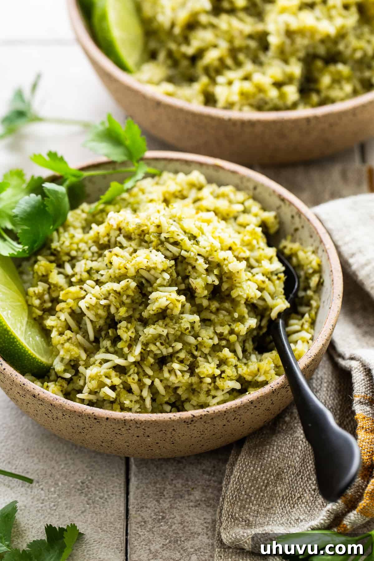 Zesty Green Rice 8 A bowl of freshly prepared Arroz Verde, garnished with a sprig of fresh cilantro, ready to be enjoyed.