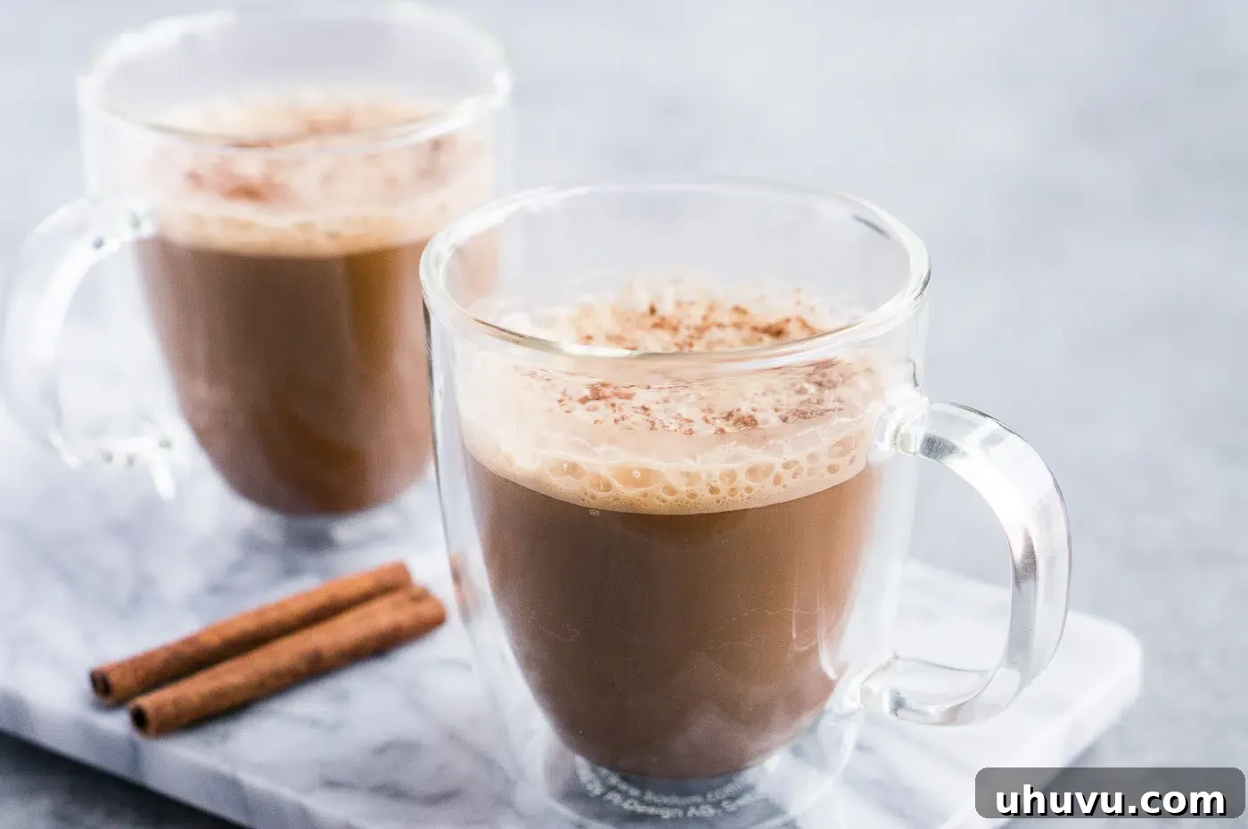 Two glass cups of creamy butter coffee, ready to be enjoyed