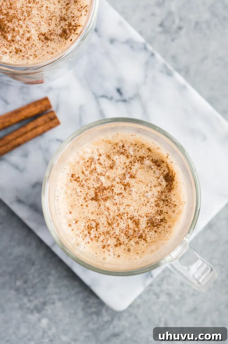 Creamy coconut oil coffee in a glass cup, showing its smooth texture