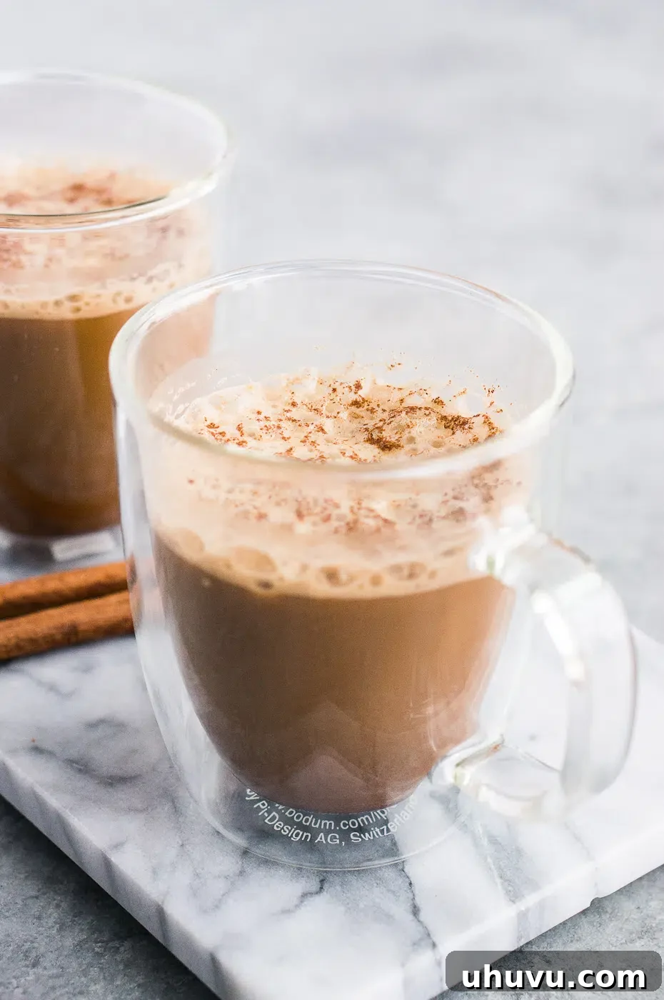 Bulletproof coffee recipe made with coconut oil and served in a glass cup with a straw