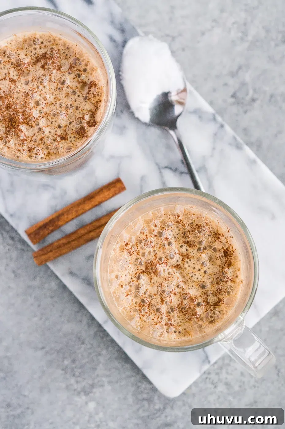 Creamy butter coffee with a sprinkle of cinnamon on top, served in a clear mug