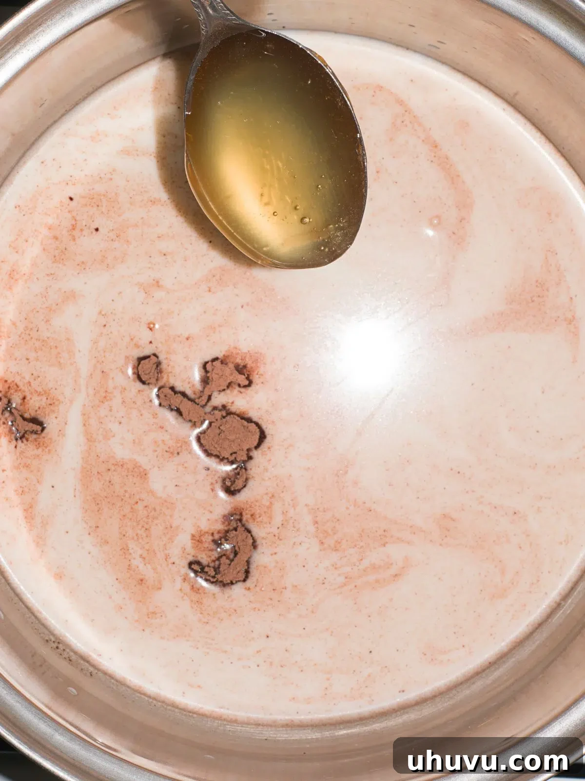 heating up milk, cocoa powder and honey