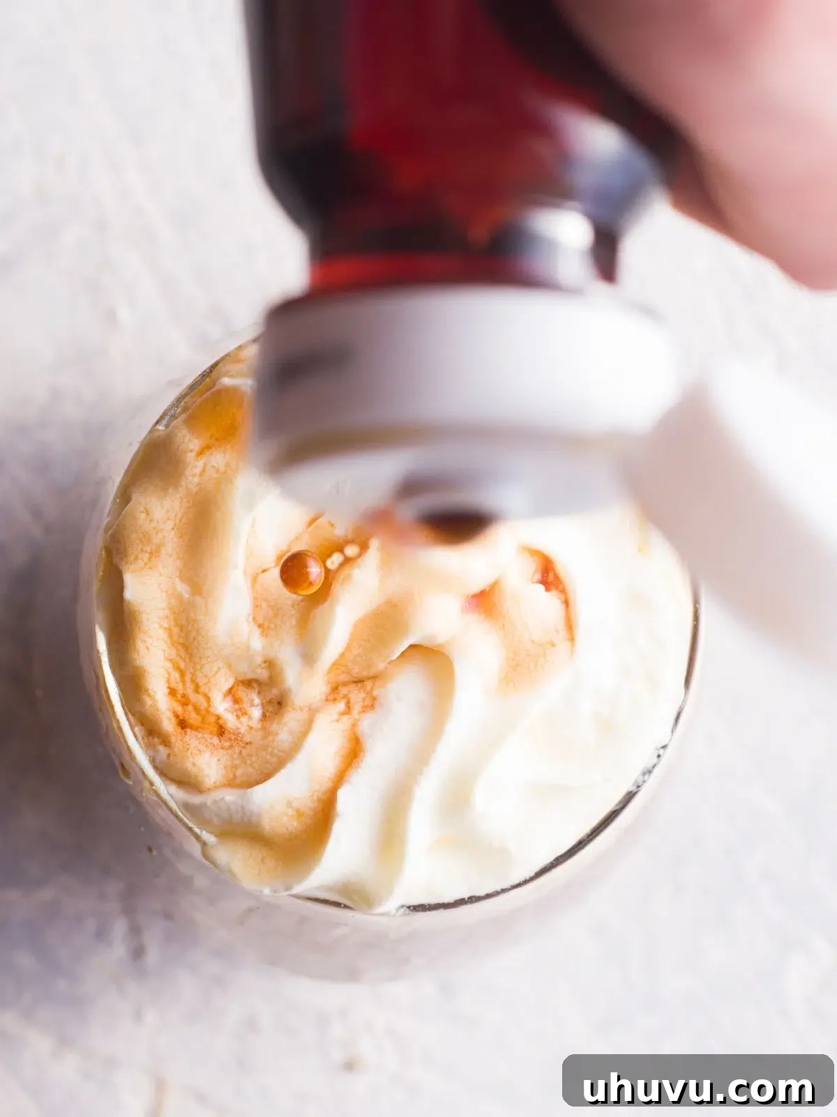 adding whipped cream and chocolate to mocha