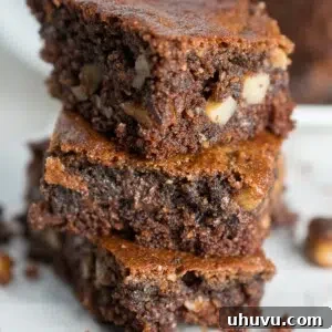 A perfectly square slice of fudgy Paleo Almond Butter Brownie, showing its rich, dark interior and subtle almond chunks.