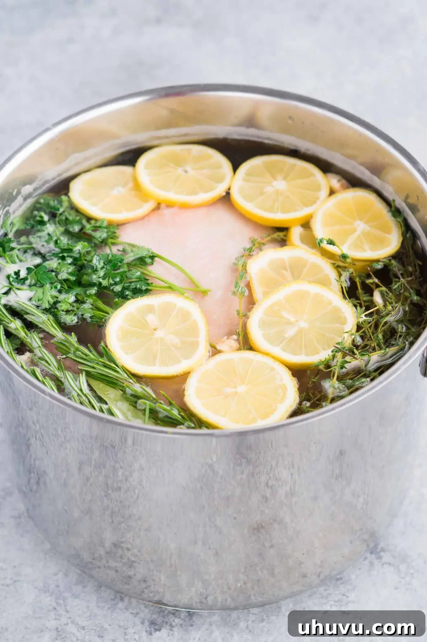 Juicy Chicken Secret 6 Close-up of a whole chicken soaking in a wet brine in a large pot