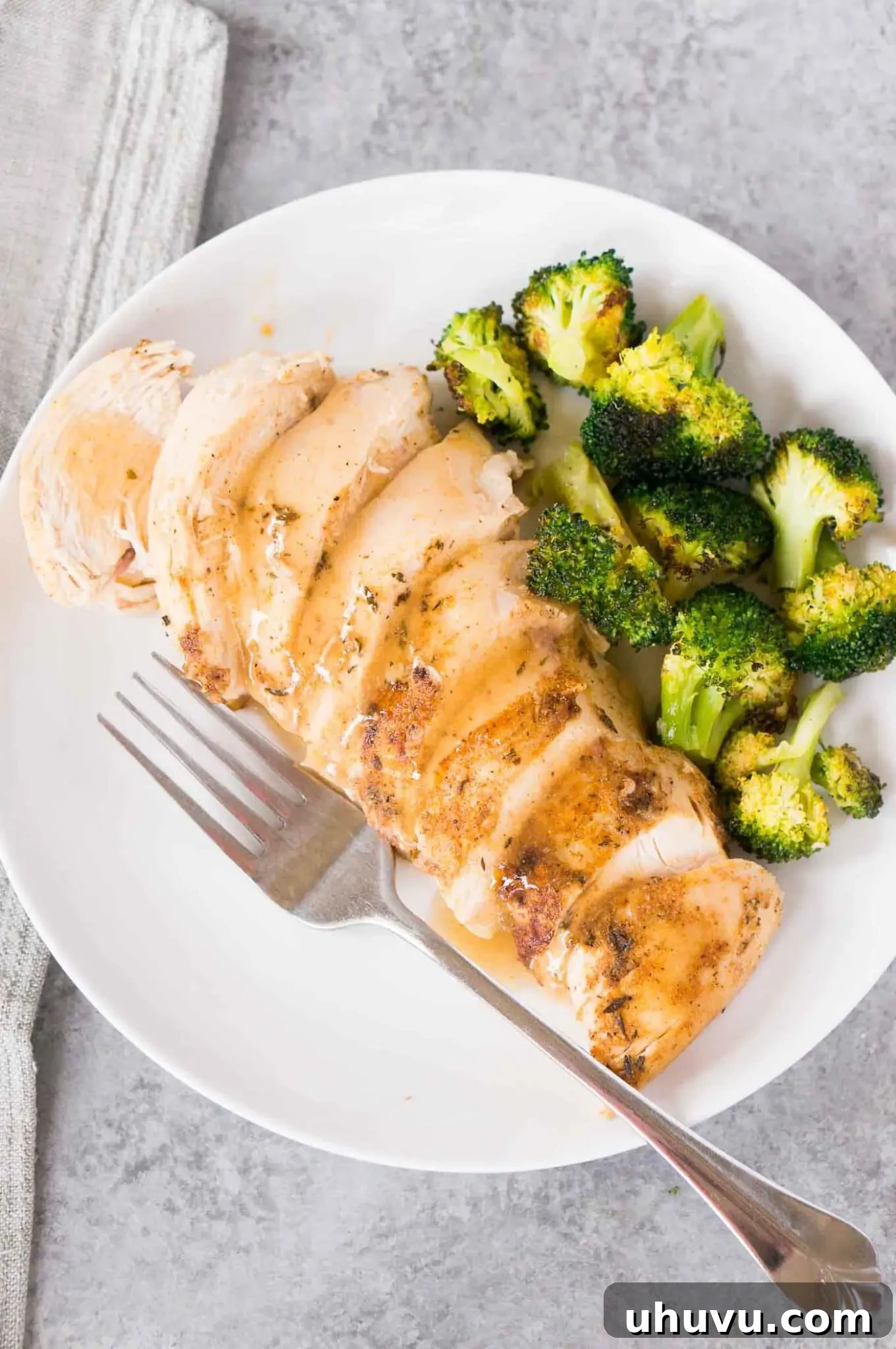sliced chicken breast with gravy on a plate