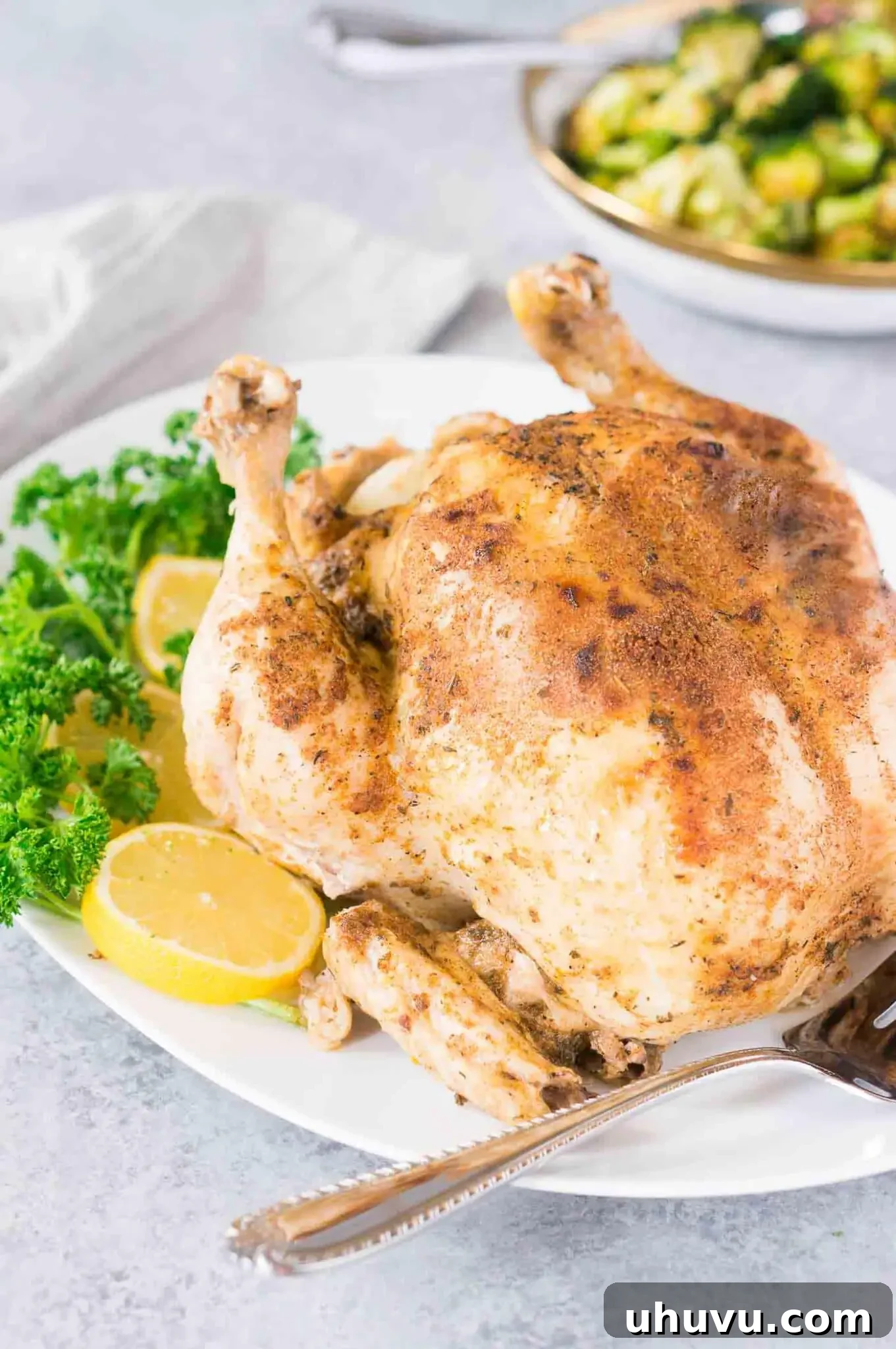pressure cooker whole chicken with lemon slices on a platter