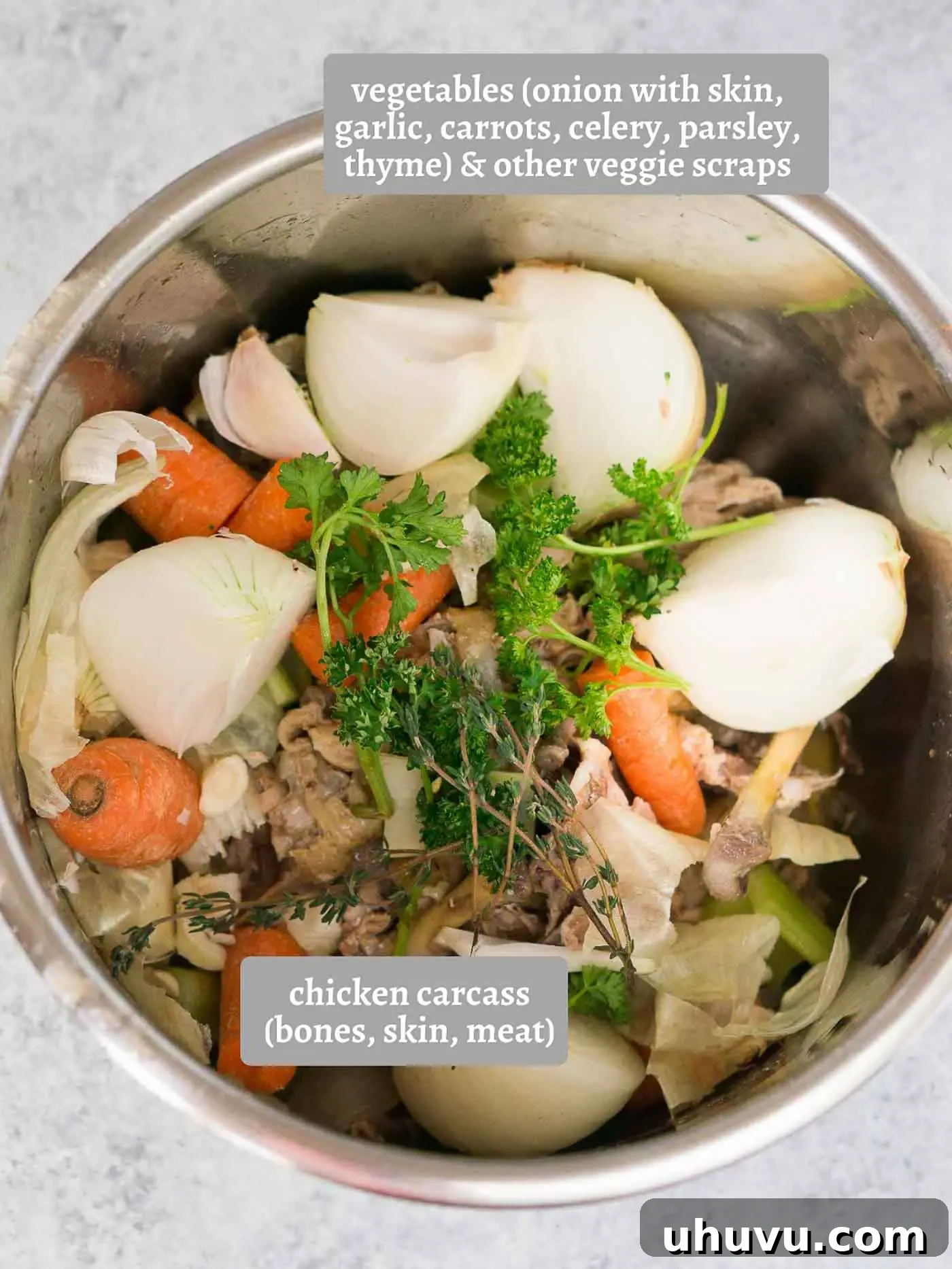 Ingredients laid out for making chicken stock, including a chicken carcass, vegetables, and spices.
