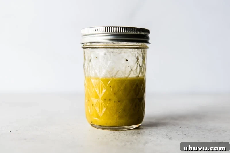 Bright Brussels Sprout Medley 5 Homemade Lemon Dijon Salad Dressing in a sealed mason jar, ready to be shaken.